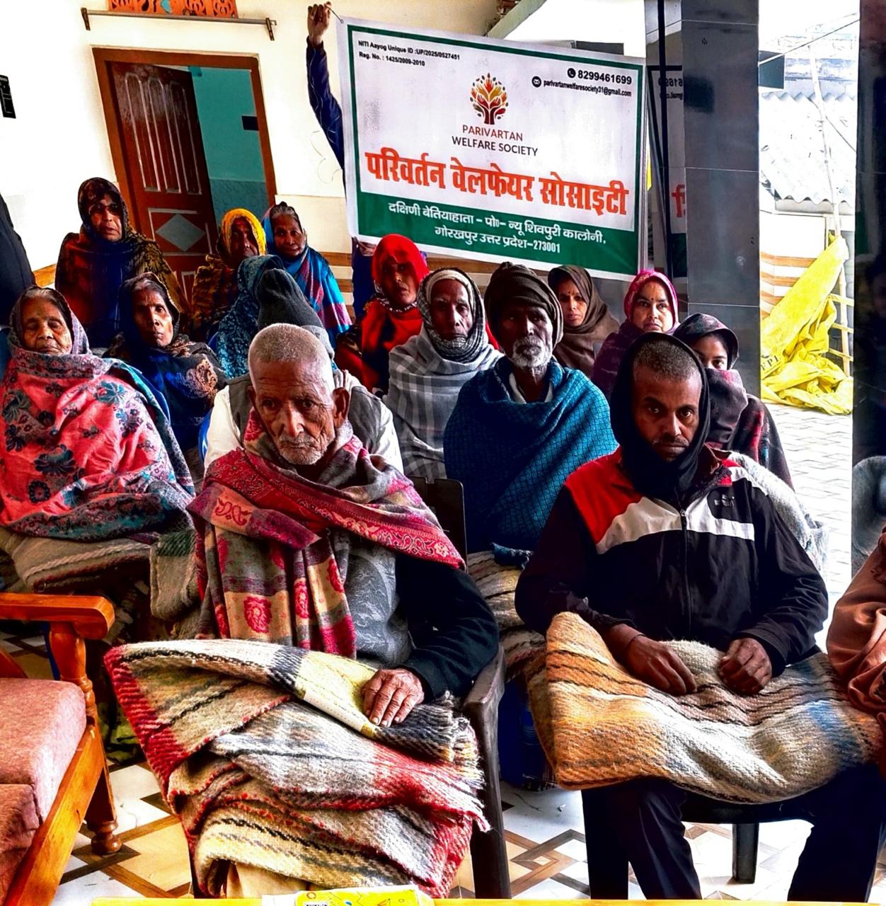 Volunteers distributing warm blankets to needy families